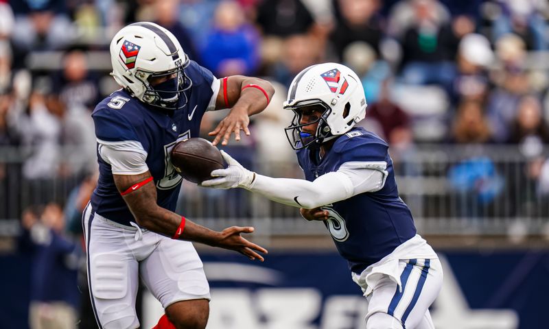 Sep 23, 2023; East Hartford, Connecticut, USA; UConn Huskies quarterback Ta'Quan Roberson (6) hands off the ball to running back Jalen Mitchell (5) against the Duke Blue Devils in the second quarter at Rentschler Field at Pratt & Whitney Stadium. Mandatory Credit: David Butler II-USA TODAY Sports