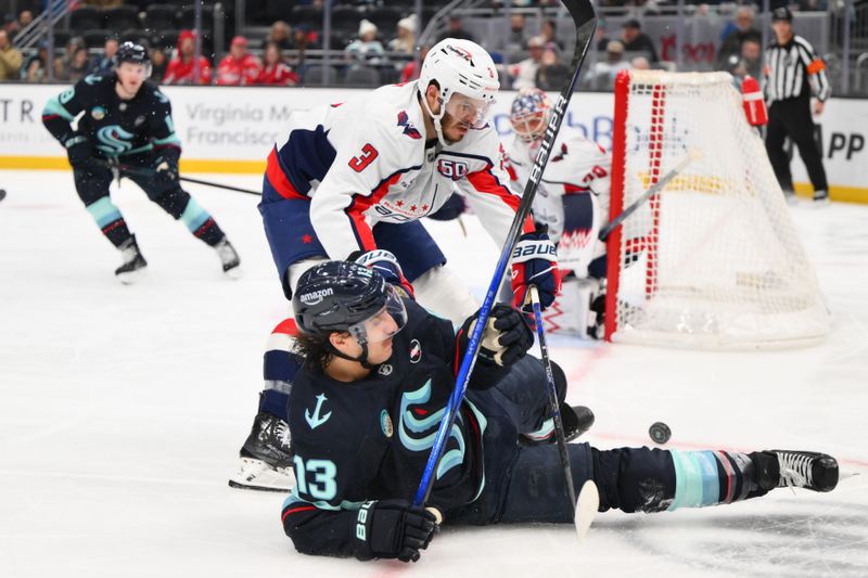 Jan 23, 2025; Seattle, Washington, USA; Washington Capitals defenseman Matt Roy (3) and Seattle Kraken left wing Brandon Tanev (13) play the loose puck during the third period at Climate Pledge Arena. Mandatory Credit: Steven Bisig-Imagn Images