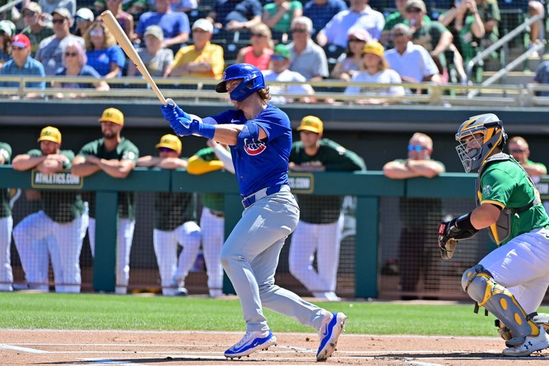 Mar 20, 2024; Mesa, Arizona, USA;  Chicago Cubs second baseman Nico Hoerner (2) grounds out in the first inning against the Oakland Athletics during a spring training game at Hohokam Stadium. Mandatory Credit: Matt Kartozian-USA TODAY Sports