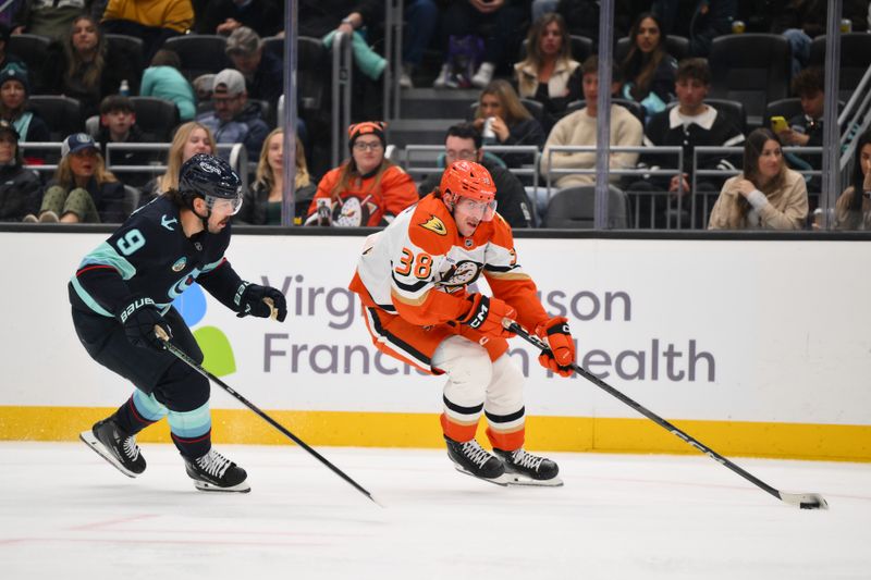 Nov 27, 2024; Seattle, Washington, USA; Anaheim Ducks center Jansen Harkins (38) advances the puck while defended by Seattle Kraken center Chandler Stephenson (9) during the second period at Climate Pledge Arena. Mandatory Credit: Steven Bisig-Imagn Images