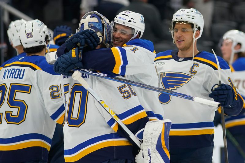 Oct 24, 2024; Toronto, Ontario, CAN; St. Louis Blues forward Mathieu Joseph (71) and forward Brayden Schenn (10) congratulate goaltender Jordan Binnington (50) after a win over the Toronto Maple Leafs during the third period at Scotiabank Arena. Mandatory Credit: John E. Sokolowski-Imagn Images