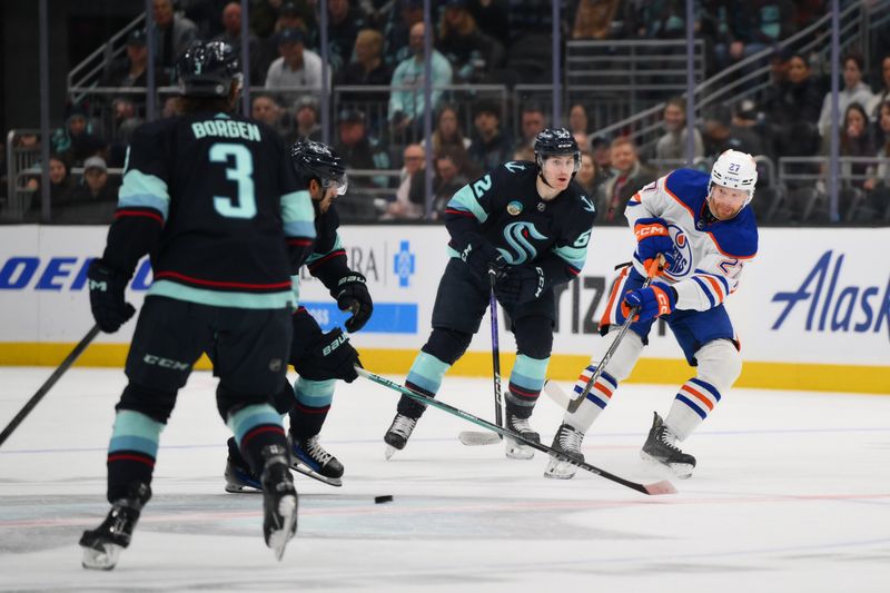 Mar 2, 2024; Seattle, Washington, USA; Edmonton Oilers defenseman Brett Kulak (27) passes the puck against the Seattle Kraken during the first period at Climate Pledge Arena. Mandatory Credit: Steven Bisig-USA TODAY Sports