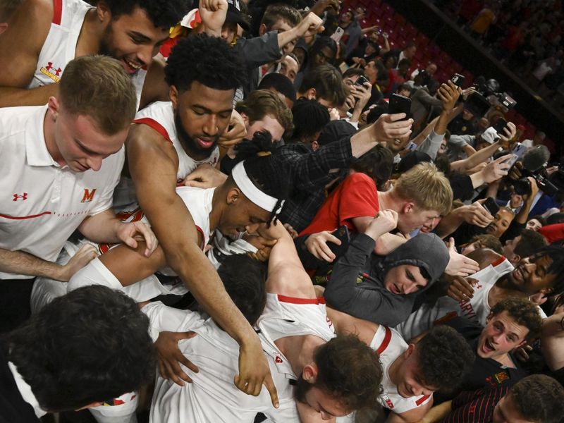 Feb 16, 2023; College Park, Maryland, USA;  Maryland Terrapins celebrates with fans on the court after the game against the Purdue Boilermakers at Xfinity Center. Maryland Terrapins defeated Purdue Boilermakers 68-54. Mandatory Credit: Tommy Gilligan-USA TODAY Sports