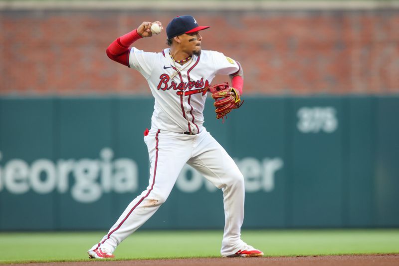 Apr 24, 2024; Atlanta, Georgia, USA; Atlanta Braves shortstop Orlando Arcia (11) throws a runner out at first against the Miami Marlins in the first inning at Truist Park. Mandatory Credit: Brett Davis-USA TODAY Sports