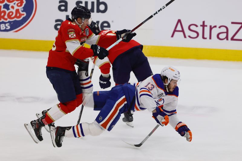 Jun 10, 2024; Sunrise, Florida, USA; Florida Panthers forward Matthew Tkachuk (19) checks Edmonton Oilers forward Mattias Janmark (13) during the first period in game two of the 2024 Stanley Cup Final at Amerant Bank Arena. Mandatory Credit: Sam Navarro-USA TODAY Sports