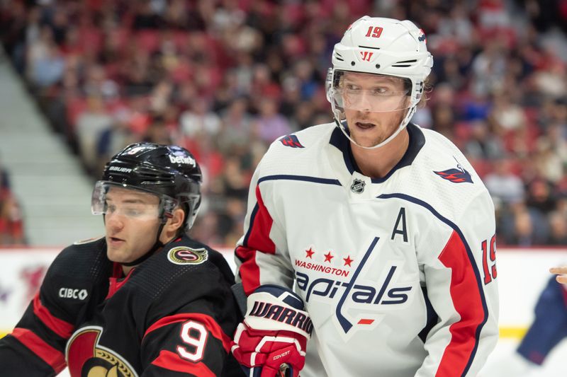 Oct 18, 2023; Ottawa, Ontario, CAN; Washington Capitals center Nicklas Backstrom (19) and Ottawa Senators center Josh Norris (9) follow the puck after facing off in the first period at the Canadian Tire Centre. Mandatory Credit: Marc DesRosiers-USA TODAY Sports