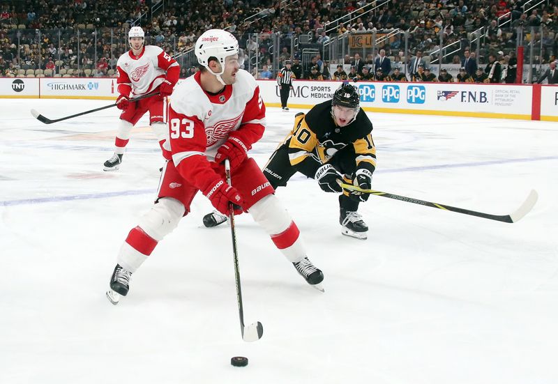 Nov 13, 2024; Pittsburgh, Pennsylvania, USA;  Detroit Red Wings right wing Alex DeBrincat (93) skates with the puck as Pittsburgh Penguins left wing Drew O'Connor (10) chases during the second period at PPG Paints Arena. Mandatory Credit: Charles LeClaire-Imagn Images