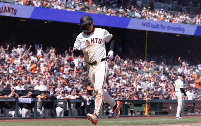 Apr 9, 2025; San Francisco, California, USA;  San Francisco Giants center fielder Jung Hoo Lee (51) scores on a wild pitch against the Cincinnati Reds during the sixth inning at Oracle Park. Mandatory Credit: Kelley L Cox-Imagn Images