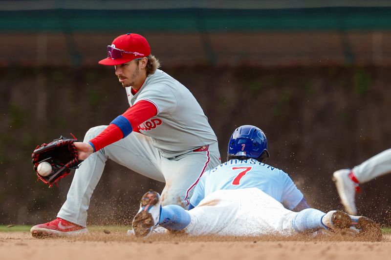 Apr 25, 2025; Chicago, Illinois, USA; Chicago Cubs shortstop Dansby Swanson (7) steals second base against Philadelphia Phillies second baseman Bryson Stott (5) during the fifth inning at Wrigley Field. Mandatory Credit: Kamil Krzaczynski-Imagn Images