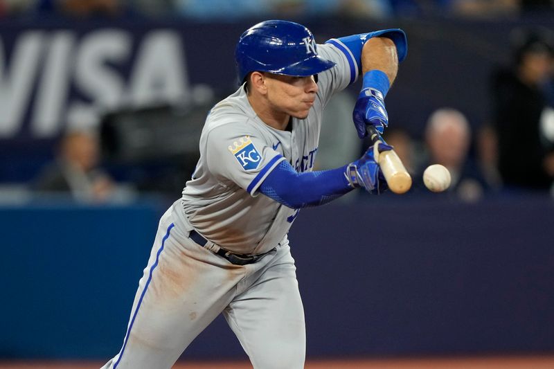 Sep 8, 2023; Toronto, Ontario, CAN; Kansas City Royals catcher Freddy Fermin (34) bunts against the Toronto Blue Jays during the fifth inning at Rogers Centre. Mandatory Credit: John E. Sokolowski-USA TODAY Sports