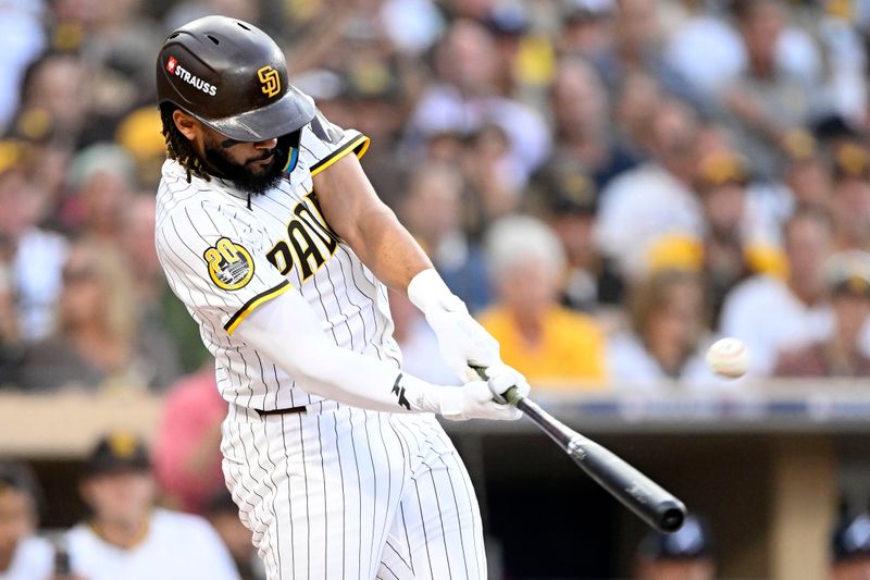 Oct 1, 2024; San Diego, California, USA; San Diego Padres outfielder Fernando Tatis Jr. (23) hits a two run home run against the Atlanta Braves during the first inning in game one of the Wildcard round for the 2024 MLB Playoffs at Petco Park. Mandatory Credit: Denis Poroy-Imagn Images