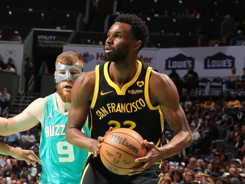 CHARLOTTE, NC - MARCH 29: Andrew Wiggins #22 of the Golden State Warriors handles the ball during the game against the Charlotte Hornets on March 29, 2024 at Spectrum Center in Charlotte, North Carolina. NOTE TO USER: User expressly acknowledges and agrees that, by downloading and or using this photograph, User is consenting to the terms and conditions of the Getty Images License Agreement. Mandatory Copyright Notice: Copyright 2024 NBAE (Photo by Kent Smith/NBAE via Getty Images)