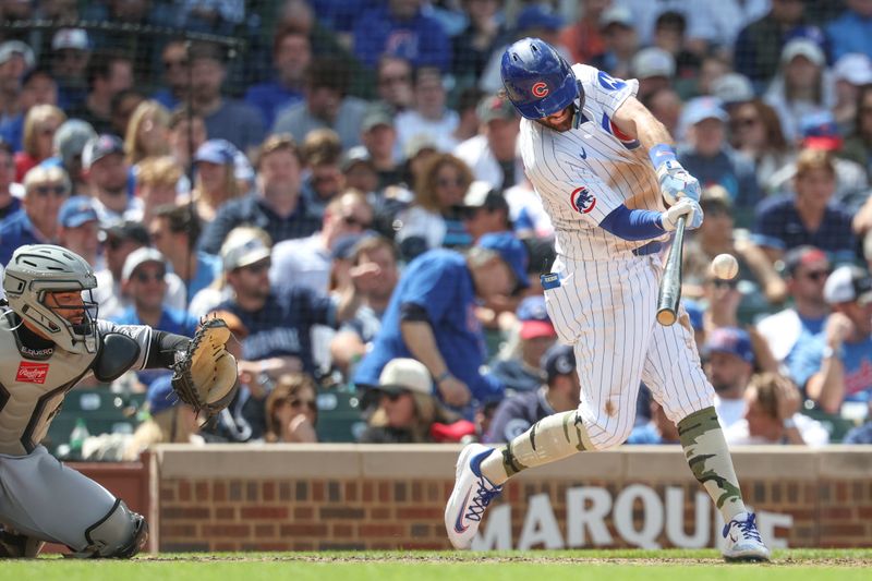 May 17, 2025; Chicago, Illinois, USA; Chicago Cubs shortstop Dansby Swanson (7) hits a solo home run against the Chicago White Sox during the fifth inning at Wrigley Field. Mandatory Credit: Kamil Krzaczynski-Imagn Images