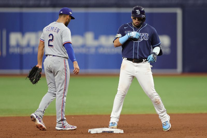 Oct 4, 2023; St. Petersburg, Florida, USA; Tampa Bay Rays third baseman Isaac Paredes (17) hits a double against the Texas Rangers in the ninth inning during game two of the Wildcard series for the 2023 MLB playoffs at Tropicana Field. Mandatory Credit: Nathan Ray Seebeck-USA TODAY Sports