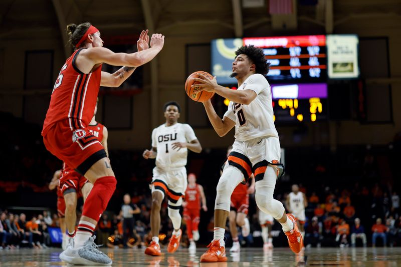 Jan 26, 2023; Corvallis, Oregon, USA; Oregon State Beavers guard Jordan Pope (0) drives to the basket while guarded by Utah Utes guard Gabe Madsen (55) during the first half at Gill Coliseum. Mandatory Credit: Soobum Im-USA TODAY Sports