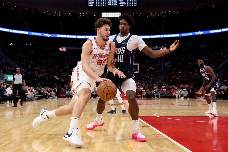 HOUSTON, TEXAS - DECEMBER 22: Alperen Sengun #28 of the Houston Rockets drives to the basket while defended by Olivier-Maxence Prosper #18 of the Dallas Mavericks in the second half at Toyota Center on December 22, 2023 in Houston, Texas.   NOTE TO USER: User expressly acknowledges and agrees that, by downloading and or using this photograph, User is consenting to the terms and conditions of the Getty Images License Agreement. (Photo by Tim Warner/Getty Images)