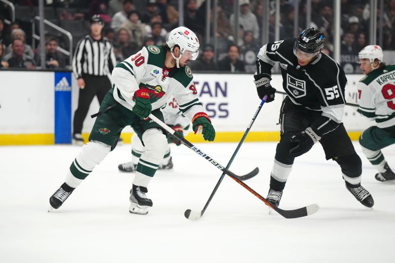 Apr 15, 2024; Los Angeles, California, USA; Minnesota Wild goaltender Jesper Wallstedt (30) and LA Kings right wing Quinton Byfield (55) battle for hte puck in the second period at Crypto.com Arena. Mandatory Credit: Kirby Lee-USA TODAY Sports