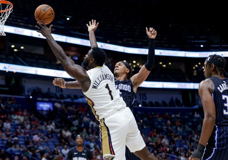 NEW ORLEANS, LOUISIANA - OCTOBER 7:  Zion Williamson #1 of the New Orleans Pelicans shoots past Paolo Banchero #5 of the Orlando Magic during the first half of a preseason game at the Smoothie King Center on October 7, 2024 in New Orleans, Louisiana. NOTE TO USER: User expressly acknowledges and agrees that, by downloading and or using this photograph, User is consenting to the terms and conditions of the Getty Images License Agreement. (Photo by Derick E. Hingle/Getty Images)