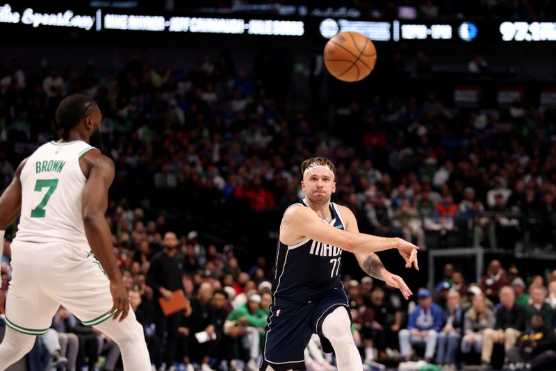 DALLAS, TEXAS - JANUARY 22: Luka Doncic #77 of the Dallas Mavericks passes the ball against Jaylen Brown #7 of the Boston Celtics in the first half at American Airlines Center on January 22, 2024 in Dallas, Texas. NOTE TO USER: User expressly acknowledges and agrees that, by downloading and or using this photograph, User is consenting to the terms and conditions of the Getty Images License Agreement. (Photo by Tim Heitman/Getty Images)