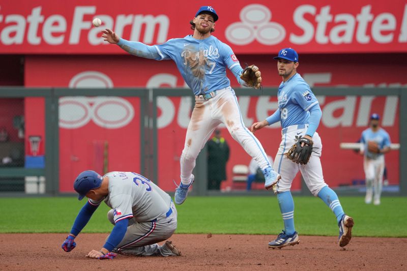 May 5, 2024; Kansas City, Missouri, USA; Kansas City Royals shortstop Bobby Witt Jr. (7) gets the out on Texas Rangers first baseman Nathaniel Lowe (30) at second base and throws to first base for a double play in the tenth inning at Kauffman Stadium. Mandatory Credit: Denny Medley-USA TODAY Sports