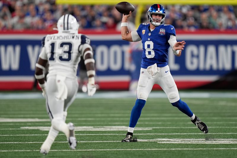 New York Giants quarterback Daniel Jones (8) passes against Dallas Cowboys linebacker DeMarvion Overshown (13) during the first quarter of an NFL football game, Thursday, Sept. 26, 2024, in East Rutherford, N.J. (AP Photo/Bryan Woolston)