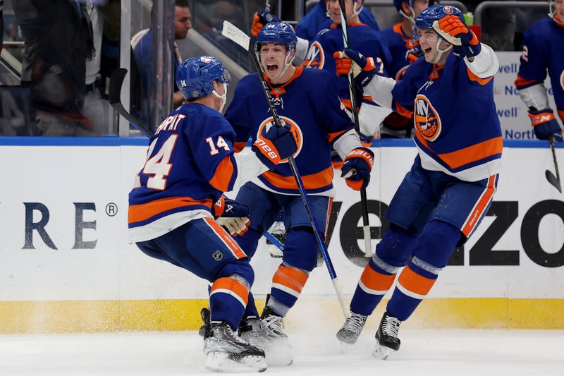 Jan 21, 2024; Elmont, New York, USA; New York Islanders center Bo Horvat (14) celebrates his game winning goal against the Dallas Stars with center Jean-Gabriel Pageau (44) and defenseman Noah Dobson (8) during overtime at UBS Arena. Mandatory Credit: Brad Penner-USA TODAY Sports