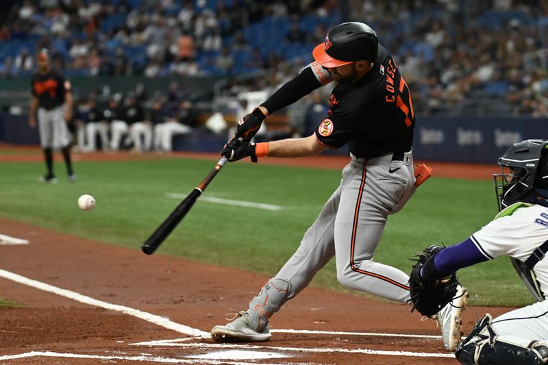 Aug 9, 2024; St. Petersburg, Florida, USA; Baltimore Orioles left fielder Colt Cowser (17) hits a solo home run in the first inning  against the Tampa Bay Rays at Tropicana Field. Mandatory Credit: Jonathan Dyer-USA TODAY Sports