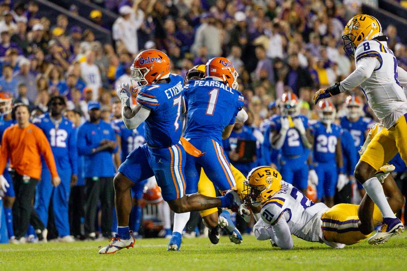 Nov 11, 2023; Baton Rouge, Louisiana, USA;  Florida Gators running back Trevor Etienne (7) rushes in for a touchdown against LSU Tigers safety Ryan Yaites (21) during the second half at Tiger Stadium. Mandatory Credit: Stephen Lew-USA TODAY Sports