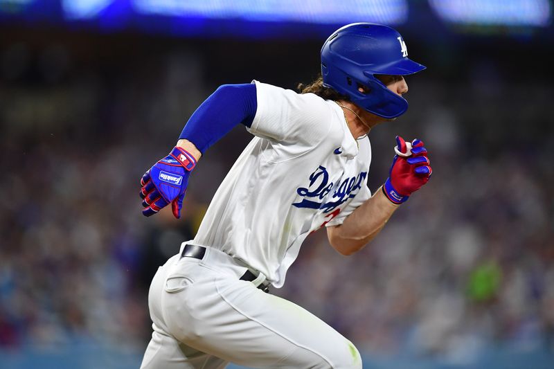 Aug 15, 2023; Los Angeles, California, USA; Los Angeles Dodgers center fielder James Outman (33) runs after hitting a single against the Milwaukee Brewers during the sixth inning at Dodger Stadium. Mandatory Credit: Gary A. Vasquez-USA TODAY Sports