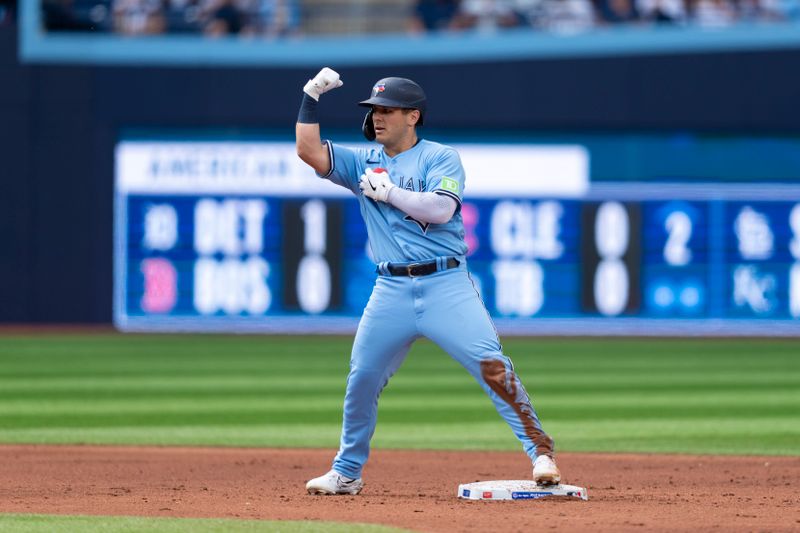 Aug 12, 2023; Toronto, Ontario, CAN; Toronto Blue Jays left fielder Daulton Varsho (25) celebrates after hitting a double against the Chicago Cubs during the third inning at Rogers Centre. Mandatory Credit: Kevin Sousa-USA TODAY Sports