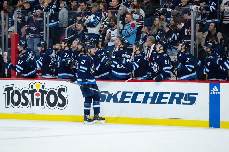 Jan 16, 2024; Winnipeg, Manitoba, CAN; Winnipeg Jets forward Gabriel Vilardi (13) is congratulated by his teammates on his goal against the New York Islanders during the first period at Canada Life Centre. Mandatory Credit: Terrence Lee-USA TODAY Sports