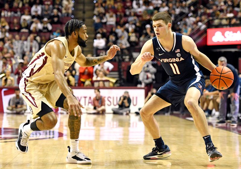 Jan 14, 2023; Tallahassee, Florida, USA; Virginia Cavaliers guard Isaac McKneely (11) works the ball around Florida State Seminoles guard Darin Green Jr (22) during the game at Donald L. Tucker Center. Mandatory Credit: Melina Myers-USA TODAY Sports