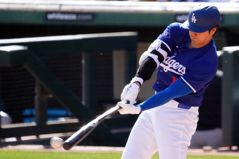 Mar 10, 2024; Phoenix, Arizona, USA; Los Angeles Dodgers designated hitter Shohei Ohtani (17) hits a double against the Arizona Diamondbacks during the sixth inning at Camelback Ranch-Glendale. Mandatory Credit: Joe Camporeale-USA TODAY Sports