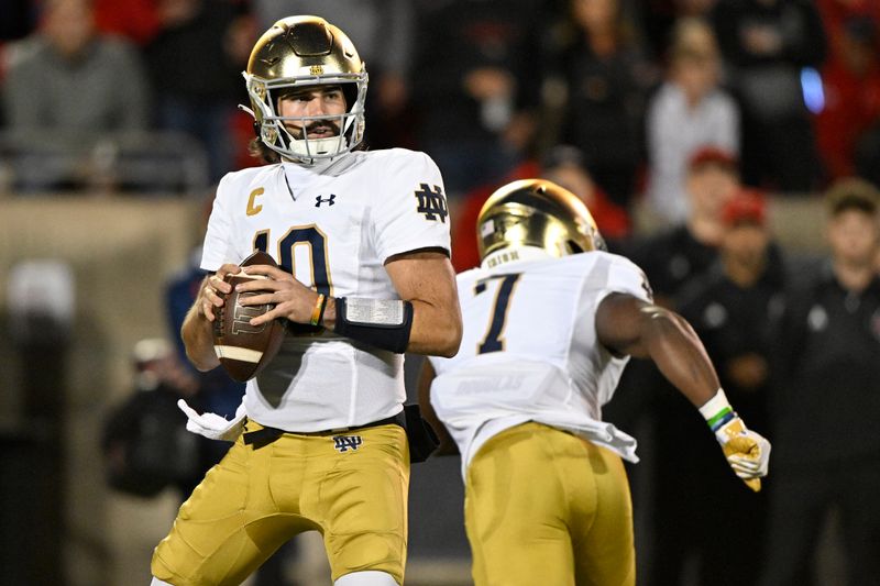 Oct 7, 2023; Louisville, Kentucky, USA;  Notre Dame Fighting Irish quarterback Sam Hartman (10) looks to pass against the Louisville Cardinals during the first quarter at L&N Federal Credit Union Stadium. Mandatory Credit: Jamie Rhodes-USA TODAY Sports