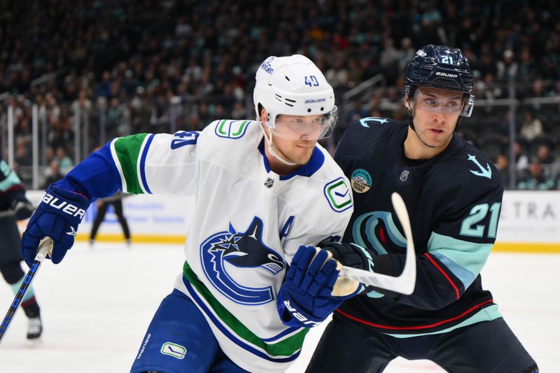 Feb 22, 2024; Seattle, Washington, USA; Vancouver Canucks center Elias Pettersson (40) and Seattle Kraken center Alex Wennberg (21) during the first period at Climate Pledge Arena. Mandatory Credit: Steven Bisig-USA TODAY Sports