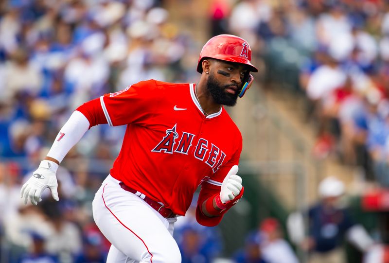 Feb 24, 2024; Tempe, Arizona, USA; Los Angeles Angels outfielder Jo Adell hits an RBI triple against the Los Angeles Dodgers during a spring training game at Tempe Diablo Stadium. Mandatory Credit: Mark J. Rebilas-USA TODAY Sports