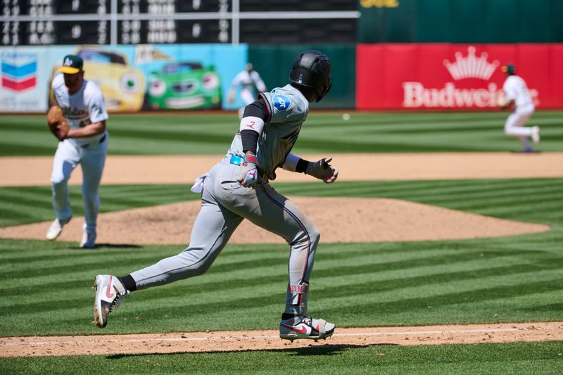 May 5, 2024; Oakland, California, USA; Miami Marlins outfielder Jazz Chisholm Jr. (2) runs to first base after hitting an RBI single against the Oakland Athletics during the sixth inning at Oakland-Alameda County Coliseum. Mandatory Credit: Robert Edwards-USA TODAY Sports