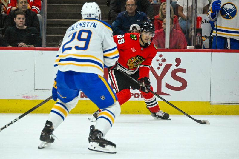 Oct 19, 2024; Chicago, Illinois, USA;  Chicago Blackhawks center Andreas Athanasiou (89) moves the puck against Buffalo Sabres left wing Beck Malenstyn (29) during the first period at the United Center. Mandatory Credit: Matt Marton-Imagn Images