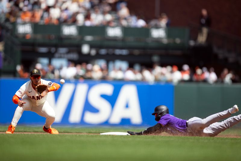 May 18, 2024; San Francisco, California, USA; Colorado Rockies center fielder Brenton Doyle (9) slides safely into second with a stolen base ahead of the throw to San Francisco Giants second baseman Thairo Estrada (39)  during the sixth inning at Oracle Park. Mandatory Credit: D. Ross Cameron-USA TODAY Sports