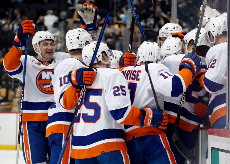 Mar 9, 2023; Pittsburgh, Pennsylvania, USA; New York Islanders celebrate a game winning goal by center Brock Nelson (29) in overtime against the Pittsburgh Penguins at PPG Paints Arena. The Islanders won 4-3 in overtime. Mandatory Credit: Charles LeClaire-USA TODAY Sports