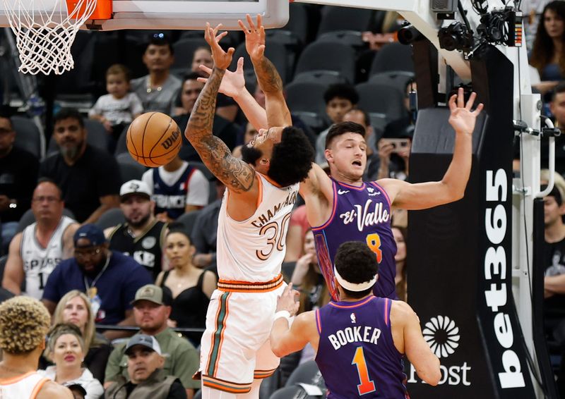 SAN ANTONIO, TX - MARCH 25:  Grayson Allen #8 of the Phoenix Suns fouls Julian Champagne #30 of the San Antonio Spurs in the first half at Frost Bank Center on March 25, 2024 in San Antonio, Texas. NOTE TO USER: User expressly acknowledges and agrees that, by downloading and or using this photograph, User is consenting to terms and conditions of the Getty Images License Agreement. (Photo by Ronald Cortes/Getty Images)