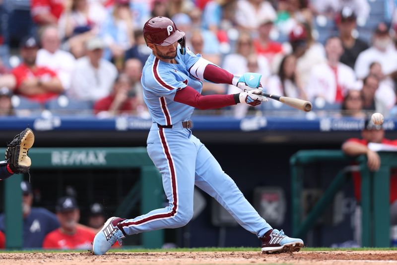 May 29, 2025; Philadelphia, Pennsylvania, USA; Philadelphia Phillies shortstop Trea Turner (7) hits an RBI single during the fifth inning against the Atlanta Braves at Citizens Bank Park. Mandatory Credit: Bill Streicher-Imagn Images