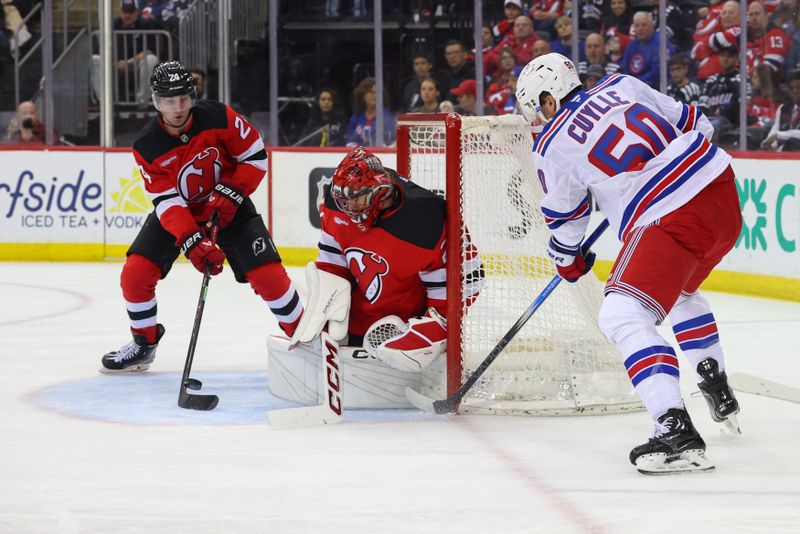 Apr 5, 2025; Newark, New Jersey, USA; New Jersey Devils goaltender Jacob Markstrom (25) makes a save on New York Rangers left wing Will Cuylle (50) during the first period at Prudential Center. Mandatory Credit: Ed Mulholland-Imagn Images