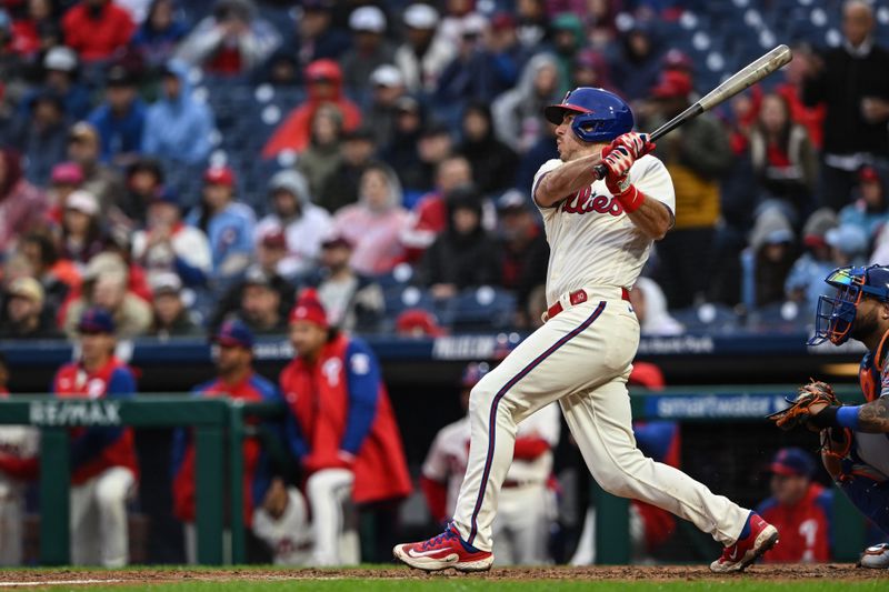 Sep 23, 2023; Philadelphia, Pennsylvania, USA;  Philadelphia Phillies catcher J.T. Realmuto (10) hits a single to right field in the fifth inning against the New York Mets at Citizens Bank Park. Philadelphia won 7-5. Mandatory Credit: John Geliebter-USA TODAY Sports