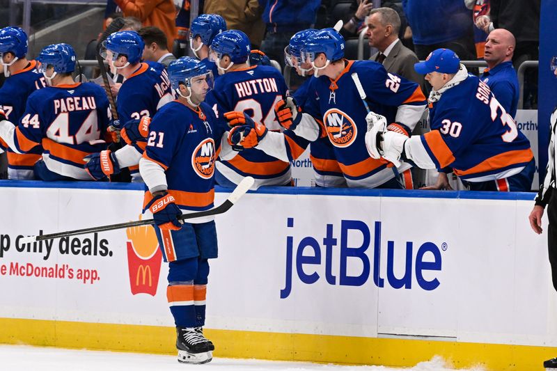 Nov 25, 2024; Elmont, New York, USA;  New York Islanders center Kyle Palmieri (21) celebrates his goal against the Detroit Red Wings with the New York Islanders bench during the second period at UBS Arena. Mandatory Credit: Dennis Schneidler-Imagn Images