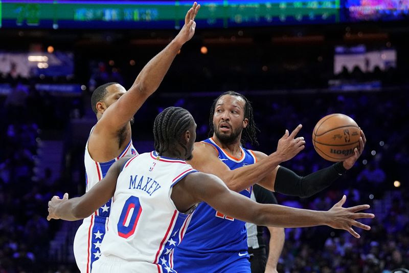 PHILADELPHIA, PENNSYLVANIA - JANUARY 15: Jalen Brunson #11 of the New York Knicks is double-teammed by Eric Gordon #23 and Tyrese Maxey #0 of the Philadelphia 76ers in the second half at the Wells Fargo Center on January 15, 2025 in Philadelphia, Pennsylvania. The Knicks defeated the 76ers 125-119 in overtime. NOTE TO USER: User expressly acknowledges and agrees that, by downloading and/or using this photograph, user is consenting to the terms and conditions of the Getty Images License Agreement. (Photo by Mitchell Leff/Getty Images)