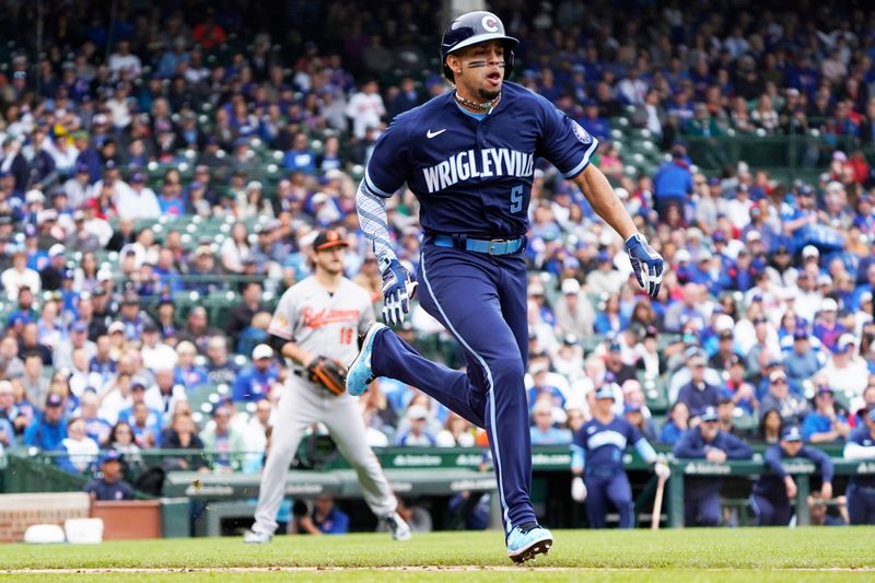 Jun 16, 2023; Chicago, Illinois, USA; Chicago Cubs center fielder Christopher Morel (5) runs to first base against the Baltimore Orioles during the first inning at Wrigley Field. Mandatory Credit: David Banks-USA TODAY Sports