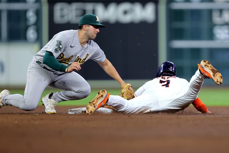 Sep 13, 2023; Houston, Texas, USA; Oakland Athletics shortstop Kevin Smith (4) tags out Houston Astros shortstop Jeremy Pena (3) on a stolen base attempt during the sixth inning at Minute Maid Park. Mandatory Credit: Erik Williams-USA TODAY Sports