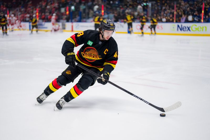 Feb 15, 2024; Vancouver, British Columbia, CAN; Vancouver Canucks defenseman Quinn Hughes (43) handles the puck during warm up prior to a game against the Detroit Red Wings at Rogers Arena.  Mandatory Credit: Bob Frid-USA TODAY Sports