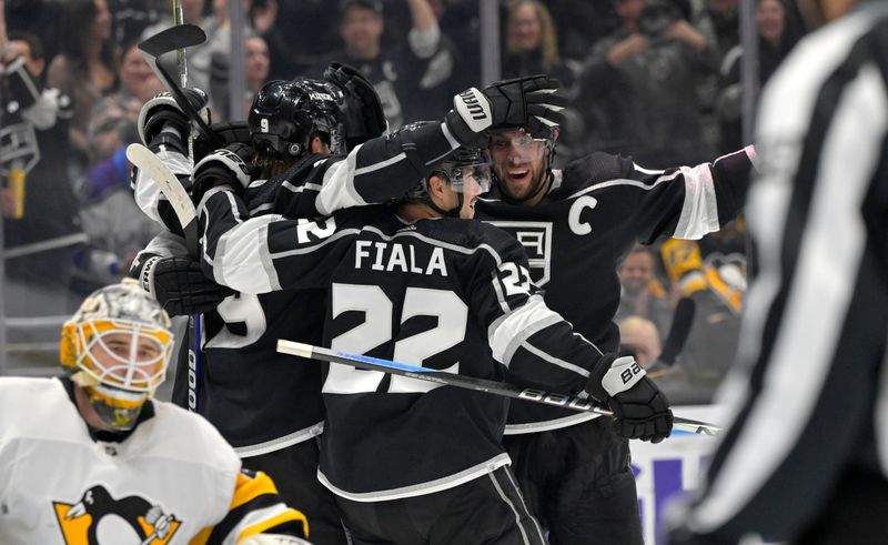 Feb 11, 2023; Los Angeles, California, USA;  Los Angeles Kings right wing Adrian Kempe (9), left, is congratulated by Los Angeles Kings left wing Kevin Fiala (22) and Los Angeles Kings center Anze Kopitar (11) after his third goal of the game in the second period against the Pittsburgh Penguins at Crypto.com Arena. Mandatory Credit: Jayne Kamin-Oncea-USA TODAY Sports